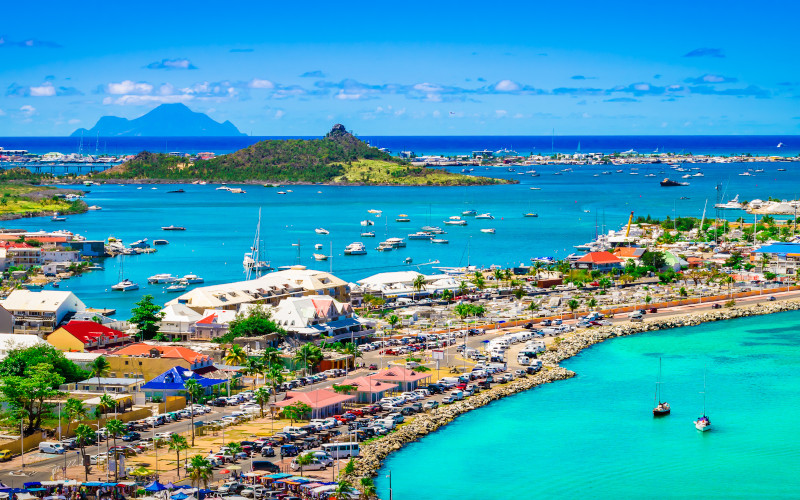 st martin beachfront and harbour with st barts in the distance